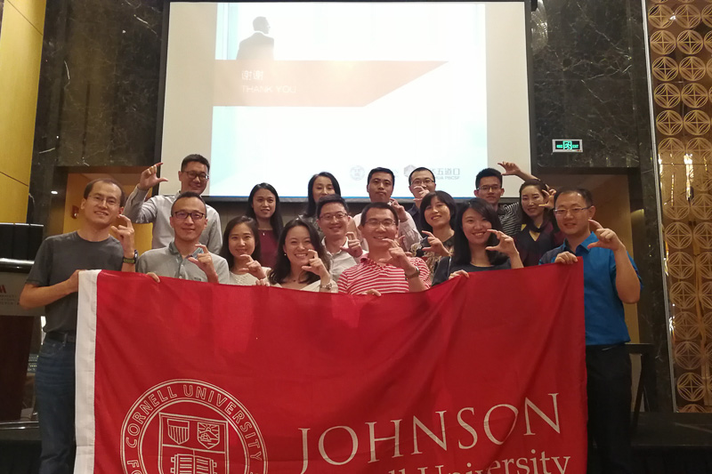 Photo of a group of people holding a Johnson banner