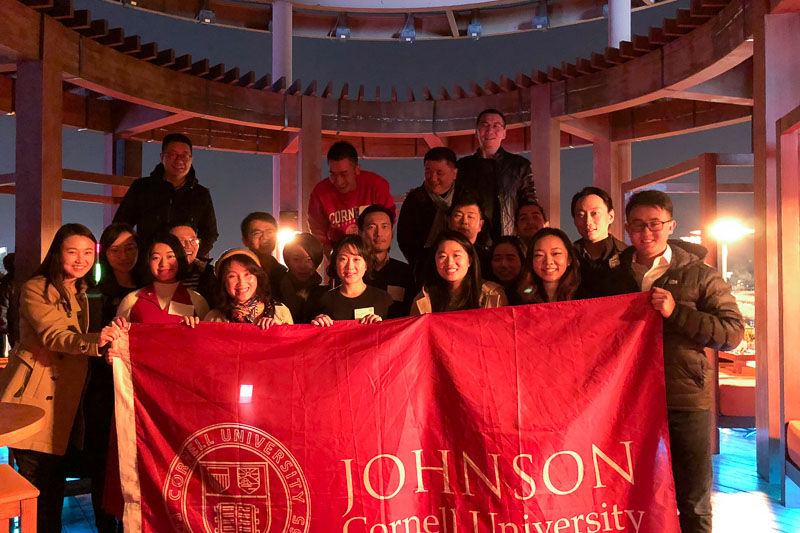 Photo of a group of people holding the Johnson banner