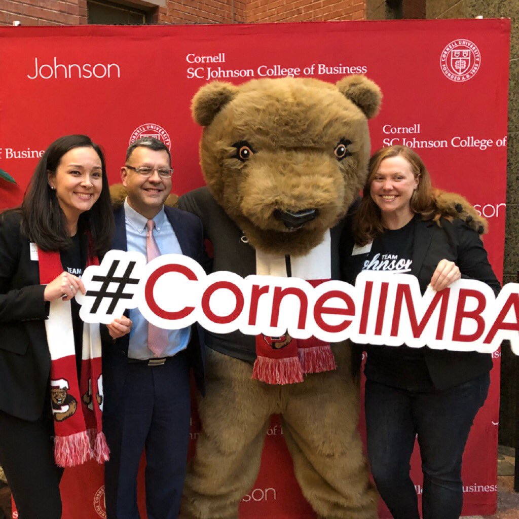 Judi, Hernan, Touchdown, and Betsy with the #CornellMBA sign