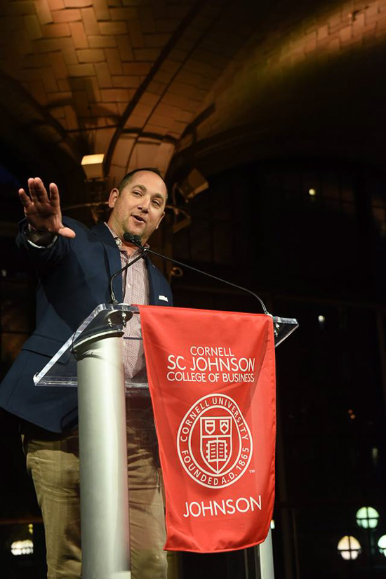 Photo of Jamey at a podium