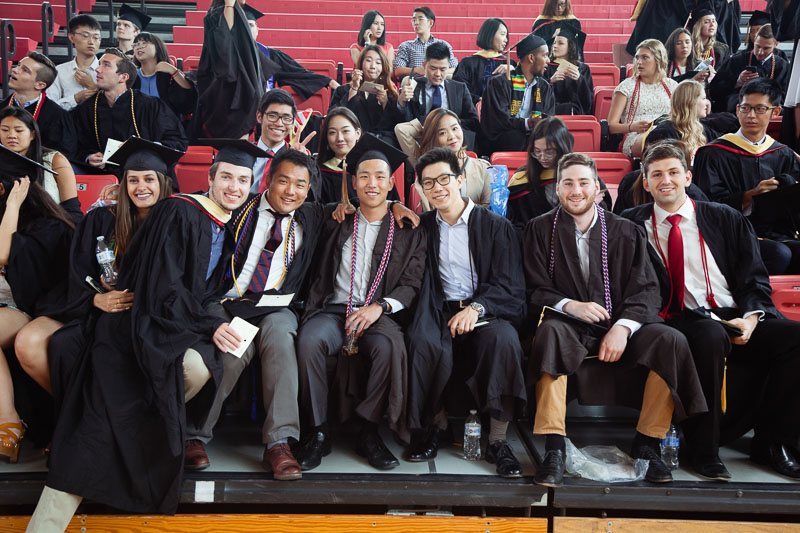 Photo of graduates sitting on bleachers