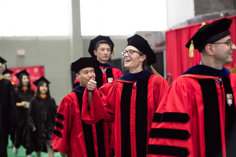 Photo of PhD graduates walking