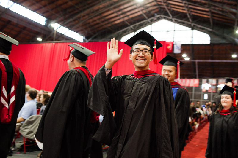 Photo of a graduate waving