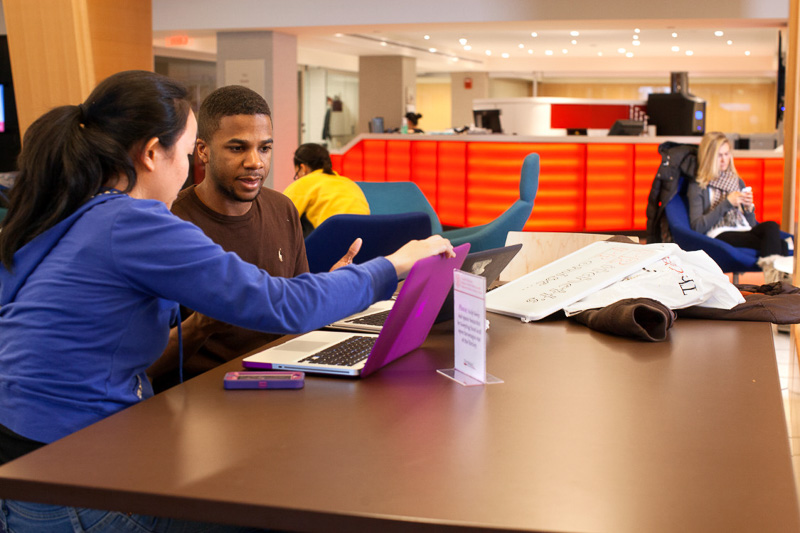 Photo of two students working at a table together