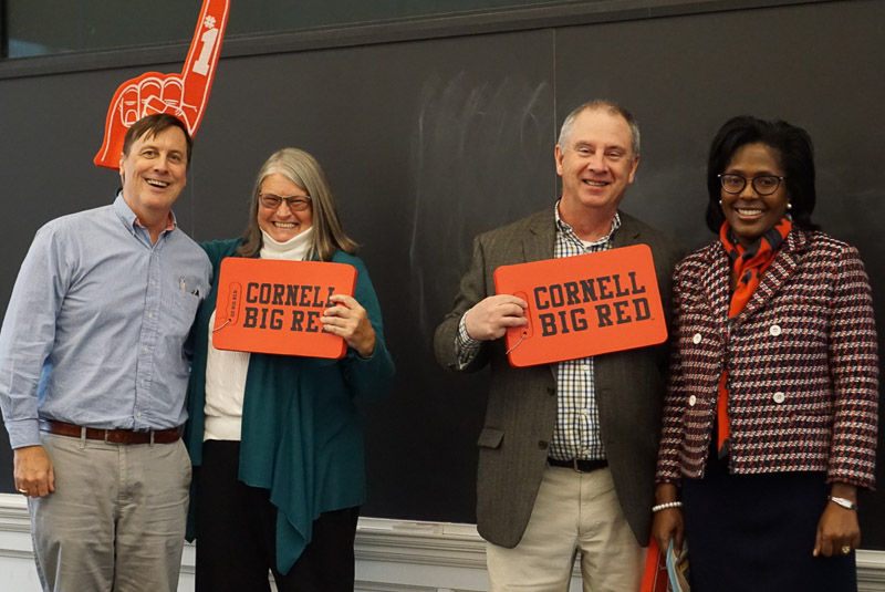 Photo of faculty holding Cornell Big Red signs