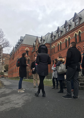 Photo of admitted students listening to a tour outside Sage Hall
