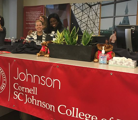 Photo of two women at the Johnson welcome desk