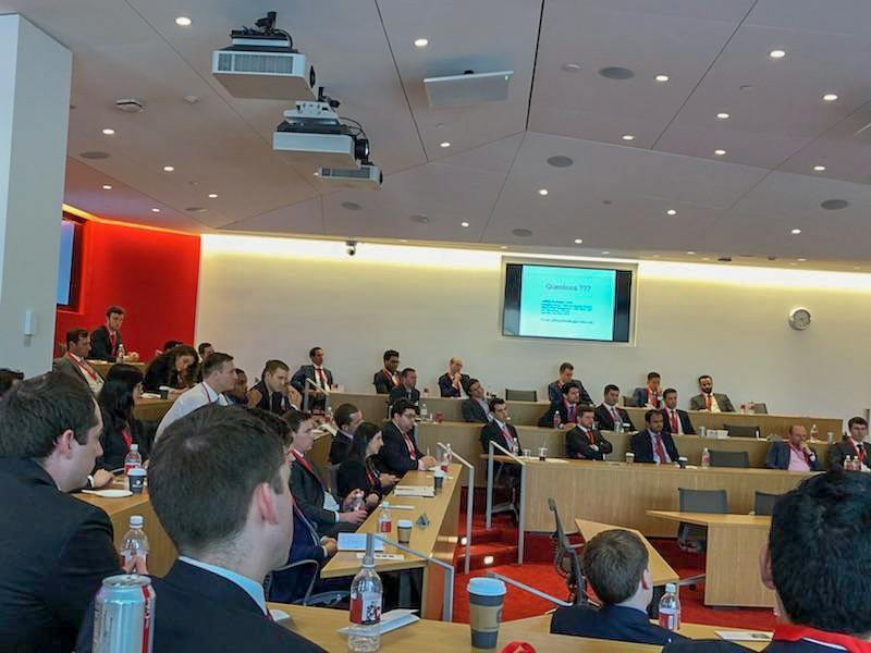 Photo of a group of people listening to speakers in a classroom