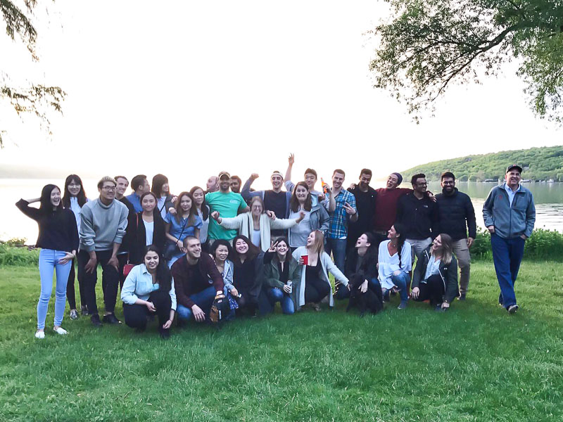 Photo of the MMH cohort making silly faces at the edge of the lake