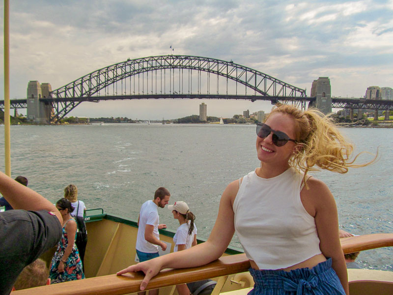 Photo of Chelsea on a boat with a bridge and city in the background