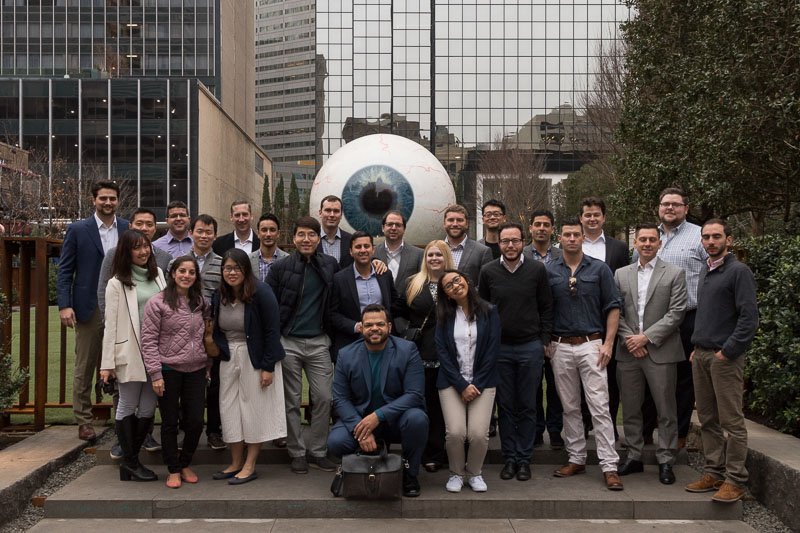 Photo of the group standing outside a building with a large eyeball statue