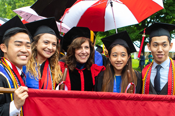 Photo of Dean Walsh and banner bearers at Commencement 2018