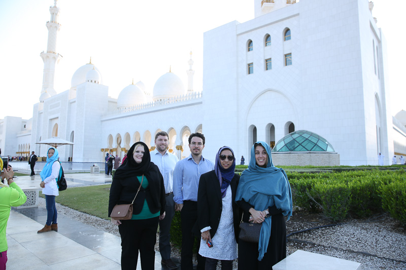 Photo of five people standing outside of a building in Dubai