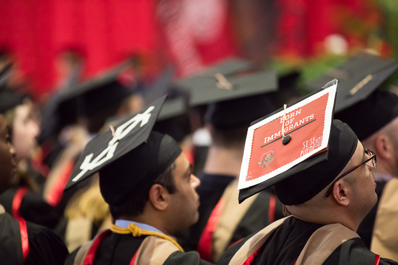 Photo of a cap that says "born of immigrants"