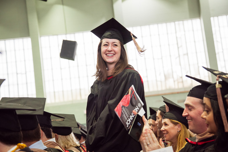 Photo of a graduate standing