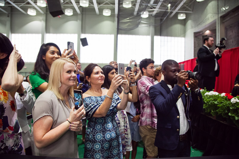 Photo of audience members taking pictures