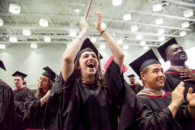 Photo of celebrating, clapping graduates