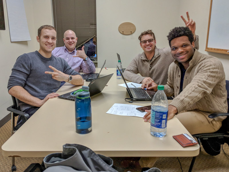 Photo of the team sitting around the table smiling