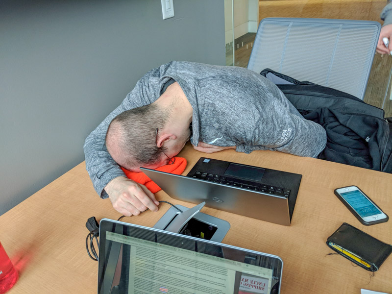 Photo of Chris with his head down on the table sleeping