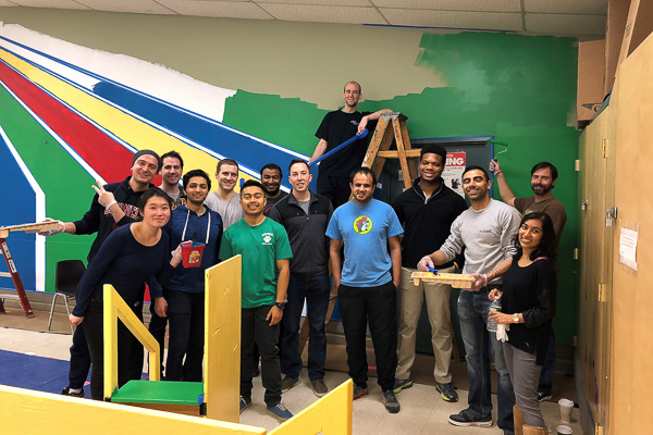 Photo of students painting a playroom