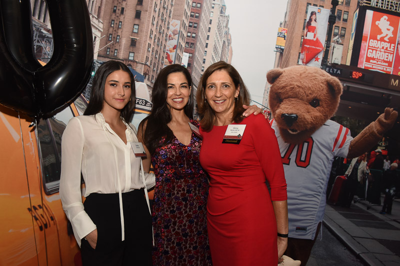 Photo of three women with Touchdown the bear outside the venue