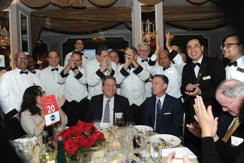 Photo of a table of guests and the wait staff