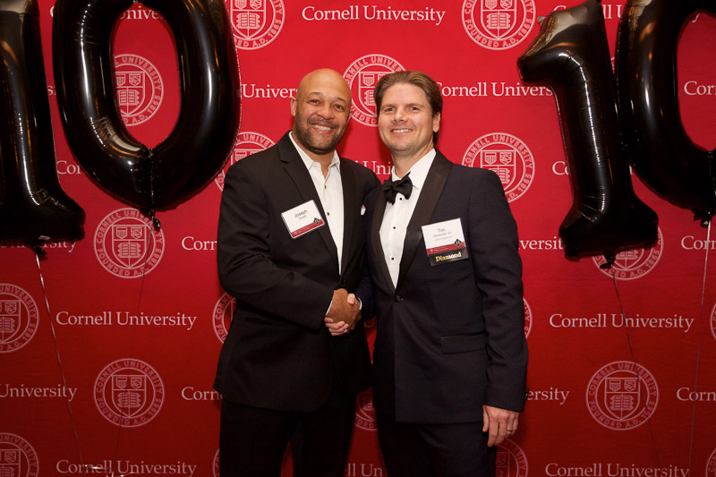 Photo of two people in front of the SHA step-and-repeat on the red carpet