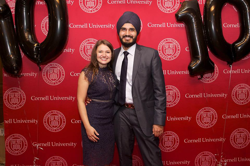 Photo of a man and woman in front of the SHA banner