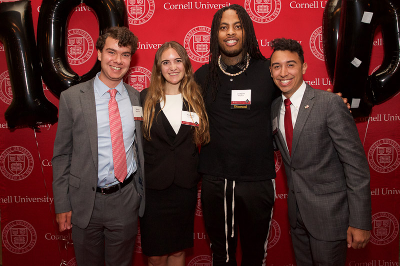 Photo of four people in front of the SHA step-and-repeat on the red carpet