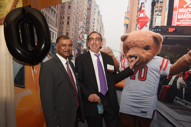 Photo of two men and touchdown the bear on a NYC street