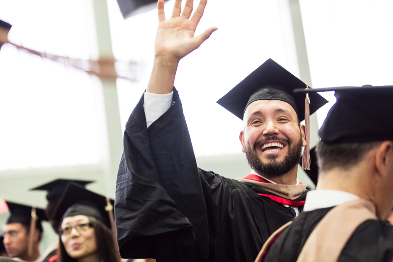 Photo of a graduate waving