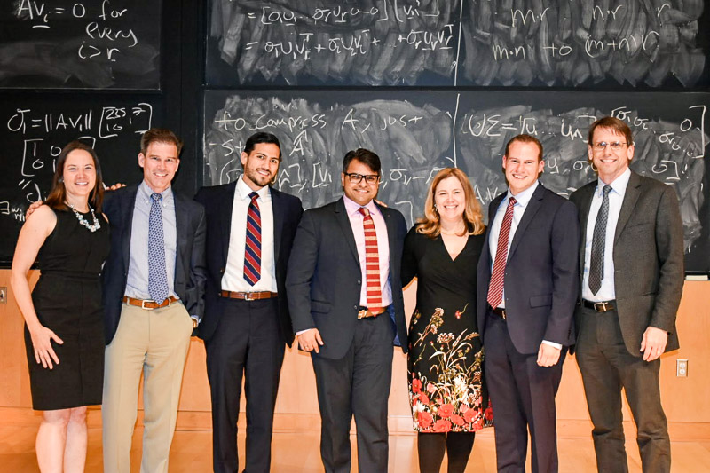 Photo of students and faculty at the front of the classroom