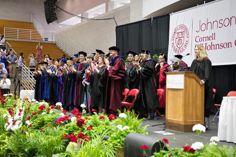 Photo of Johnson faculty applauding graduates