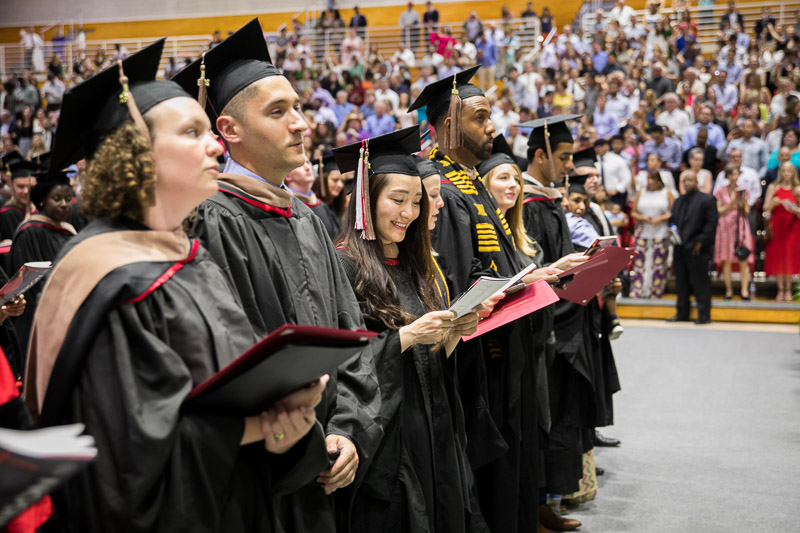 Photo of standing, singing graduates