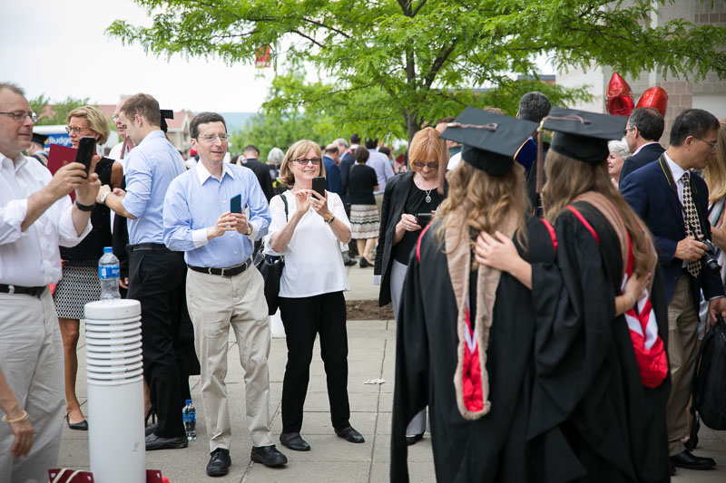 Photos of graduates having their picture taken outside