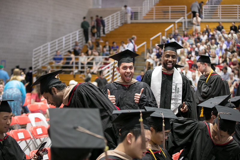 Photo of a graduate giving a thumbs up