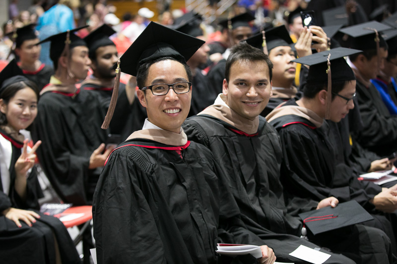 Photo of seated, smiling graduates