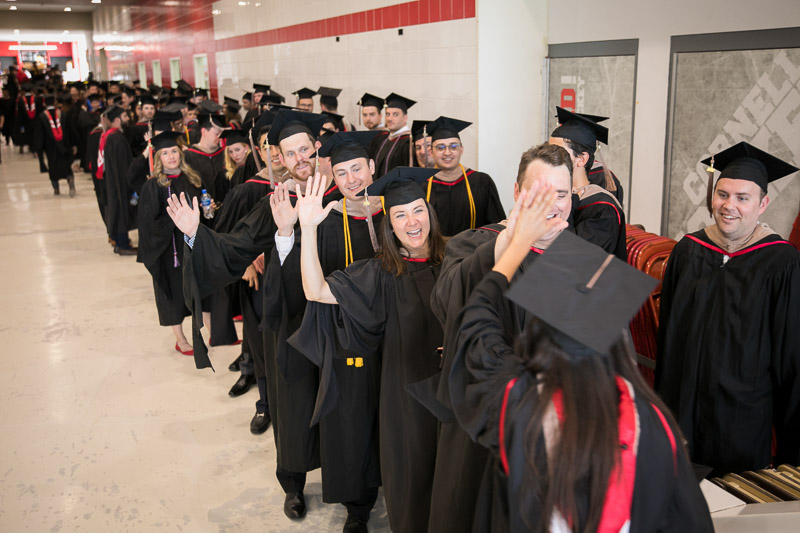 Photo of graduate standing in the staging area