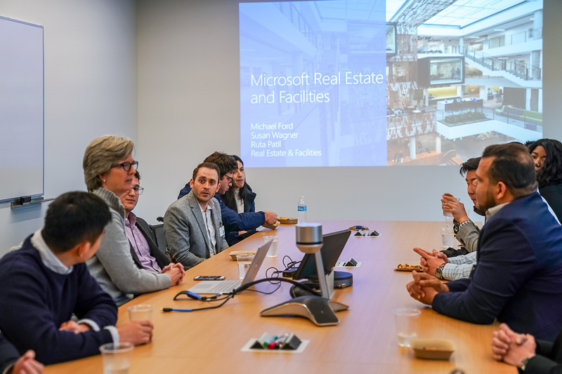 Photo of real estate students and execs sitting around a boardroom table