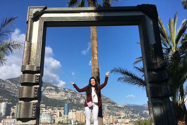 Photo of Tasha with a city and palm trees