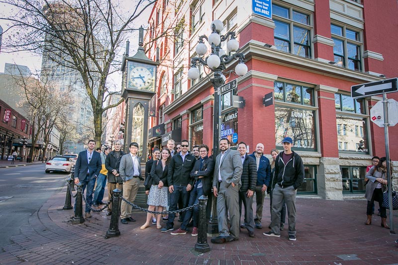 Photo of the group standing on a street corner in front of a brick building