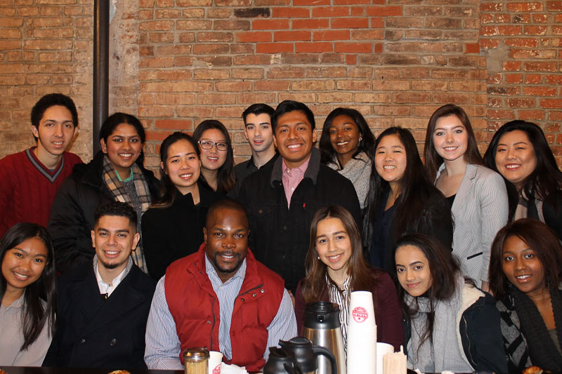 Photo of a group of people sitting around a table