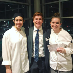 Photo of three students, two are wearing chefs attire