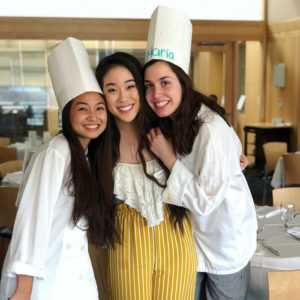 Photo of three students, two are wearing chefs attire