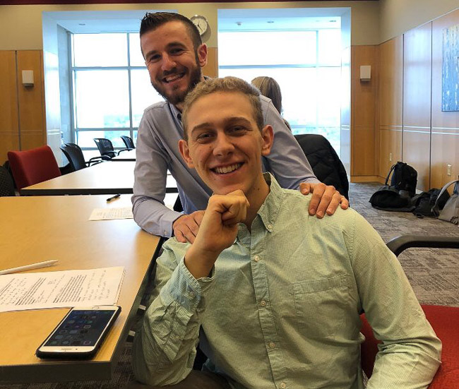 Photo of two students sitting at a table