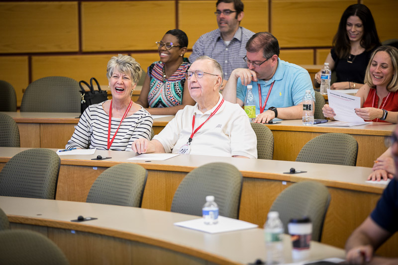 Photo of a man and woman laughing in the audience