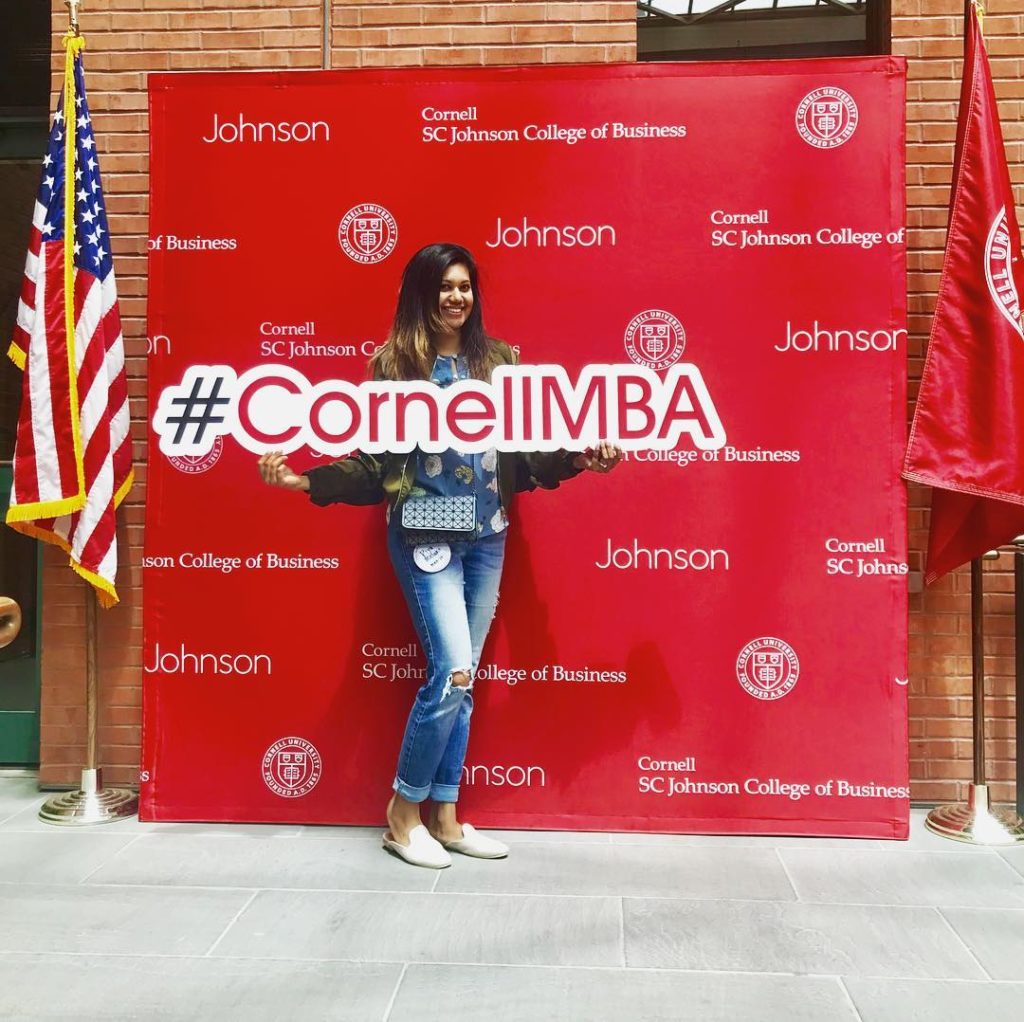 Piya holding a #CornellMBA sign at Reunion