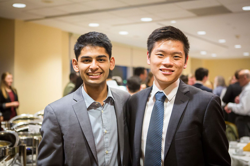 Photo of two male students at a reception