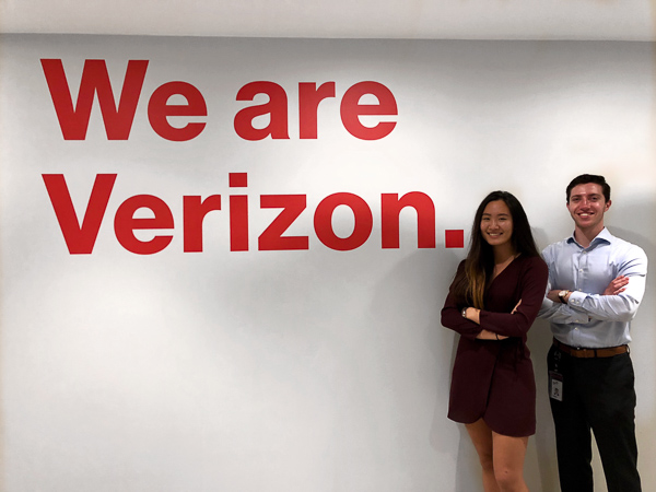 Teresa Liang and Matt Stern in front off We are Verizon sign