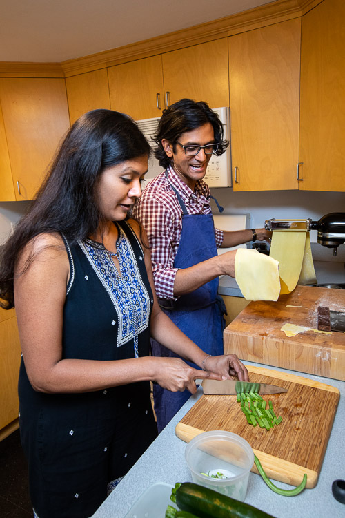 Photo of Aaron and his wife cooking in their kitchen together